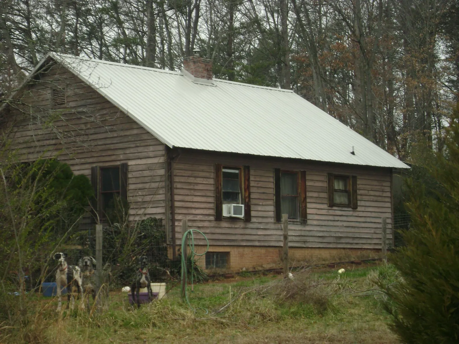 White metal roof on an old wood sided farmhouse, from a Metal Roof Installation job in Exira